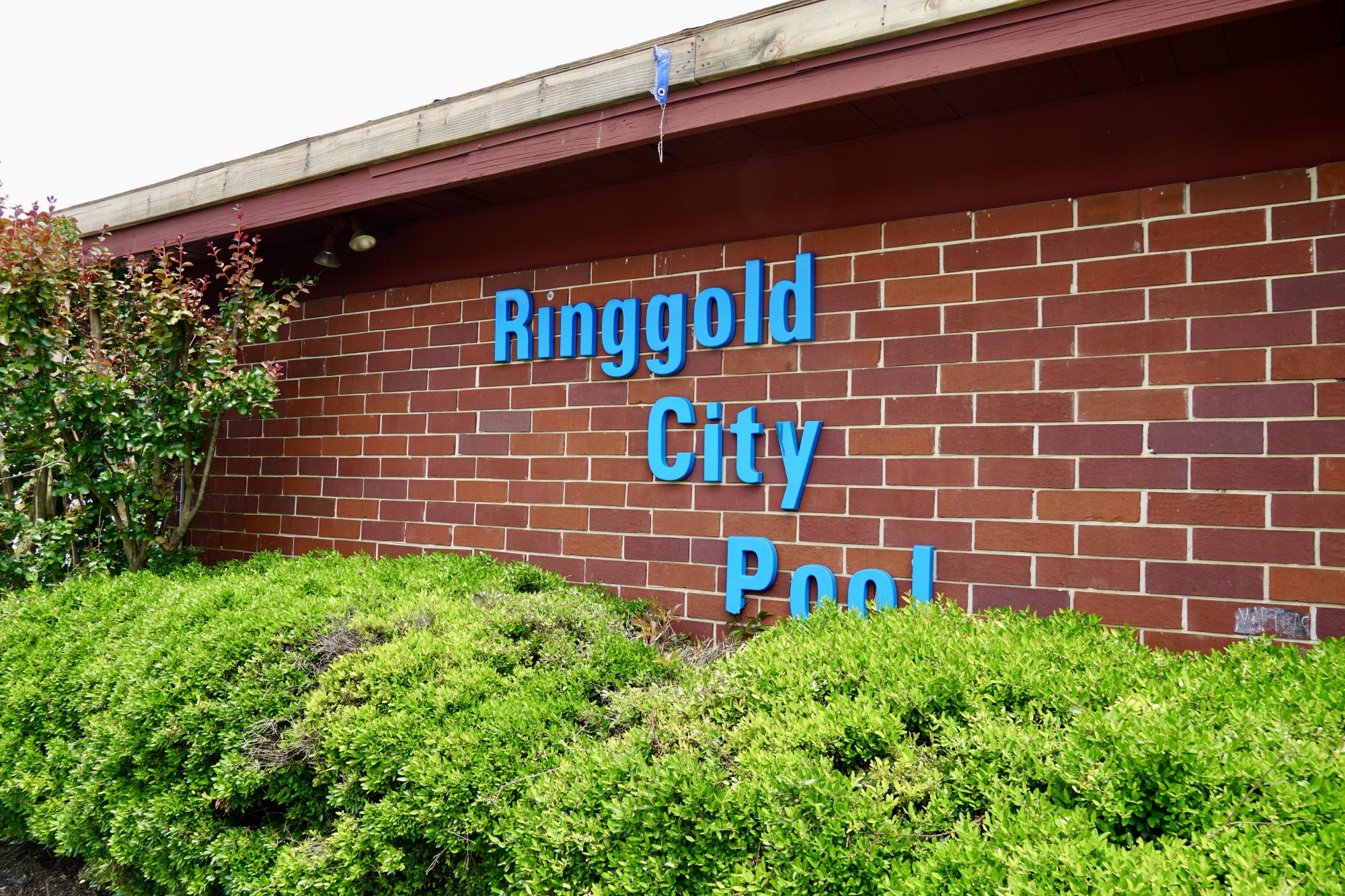 Brick building with pool name